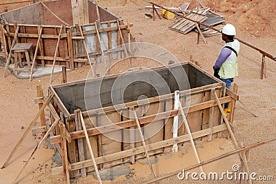 Construction workers installing & fabricating ground beam timber form works at the construction site. Editorial Stock Photo