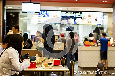 KUALA LUMPUR , MALAYSIA â€“ MARCH 16, 2020. People using rubber gloves when eating in fast food restaurant. Washing hands has just Editorial Stock Photo