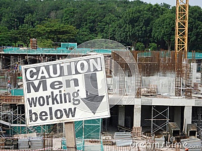 Safety signage `CAUTION - Men Working Below` at the construction site. Editorial Stock Photo