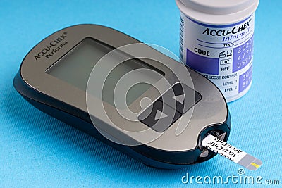 Accu Chek Performa Digital Blood Glucose Meter closeup for Diabetes on blue background Editorial Stock Photo