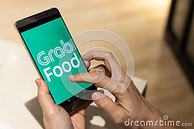 KUALA LUMPUR, MALAYSIA, September 17, 2019: Conceptual of person ordering food online via Grabfood app on smart phone. Grabfood is Editorial Stock Photo