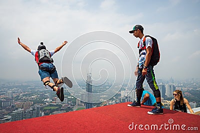 A BASE jumpers in jumps off from KL Tower. Editorial Stock Photo