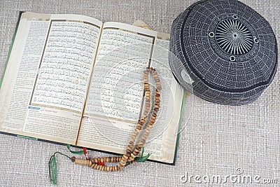 KUALA LUMPUR, 18 May 2016: The Holy Quran,Tasbih and kopiah hat. DOF and copy space Editorial Stock Photo