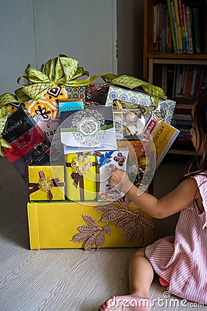 Hamper with various products wrapped in gold colour for Hari Raya Aidilfitri celebrations. Editorial Stock Photo