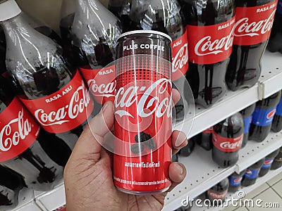 KULIM,MALAYSIA - CIRCA OCTOBER,2019 : A hand holding a can of Coca Cola Plus Coffee at supermarket Editorial Stock Photo