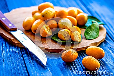 Kumquat on plate at wooden table Stock Photo