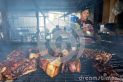 Vendor preparing a barbecue wild boar, Editorial Stock Photo