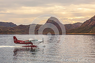 Kununurra, WA. Australia - May 18, 2013: A Cessna 208 Caravan Amphibious Float plane lands on the still waters of Lake Argyle Editorial Stock Photo