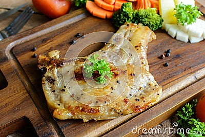 Kurobuta pork chop steak on wooden table Stock Photo