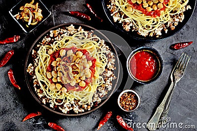Kushari or Koushari - Egyptian dish of lentils, rice, pasta, chickpeas with tomato sauce and crispy onions. Arabic cuisine Stock Photo