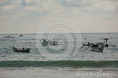 Kuta Beach Tranquility: Boats Resting on Lombok's Gentle Shores Stock Photo