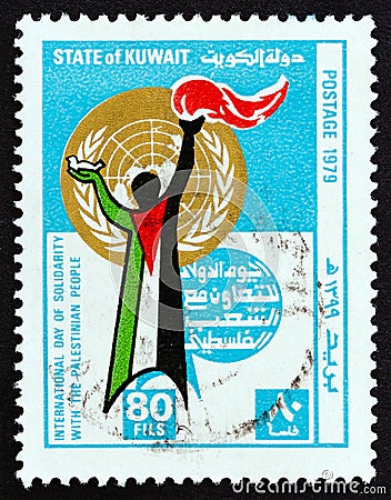 KUWAIT - CIRCA 1979: A stamp printed in Kuwait shows figure, with dove and torch, clothed in Palestinian flag, circa 1979. Editorial Stock Photo