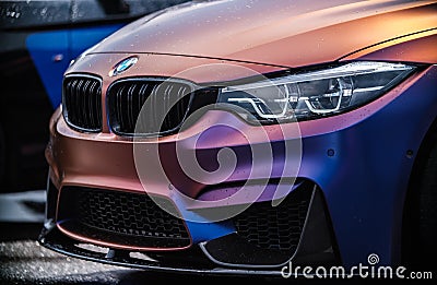 BMW M3 F80 vehicle wrapped in purple matte chameleon vinyl wrap,equipped with custom wide body kit with carbon Editorial Stock Photo