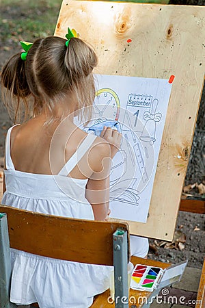 Kyiv - September 2019: Girl draws a coloring book with until September 1 Editorial Stock Photo