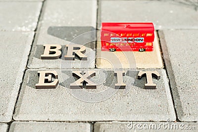 Kyiv, UA, 17.11.2017 Britain exit from European Union, Brexit word abstract in vintage letters,background double decker bus toy mo Editorial Stock Photo