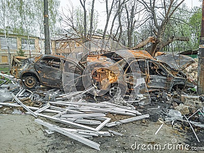 Damaged burned cars in the aftermath of a shelling in Podilskyi district of Kyiv. War in Ukraine Editorial Stock Photo