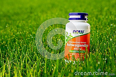 Kyiv, Ukraine - April 27, 2023: Ashwagandha root extract capsules from NOW Foods on green grass close-up. Dietary Supplement to Editorial Stock Photo