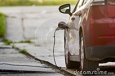 Electric car being recharged Stock Photo