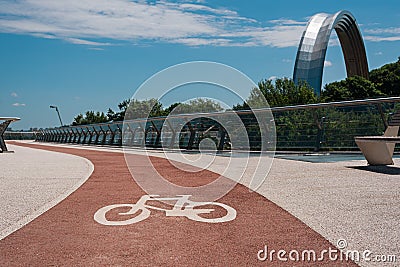 Kyiv, Ukraine - June 24, 2020. Bike path on pedestrian-bicycle bridge near the Arch of Friendship of Peoples Editorial Stock Photo