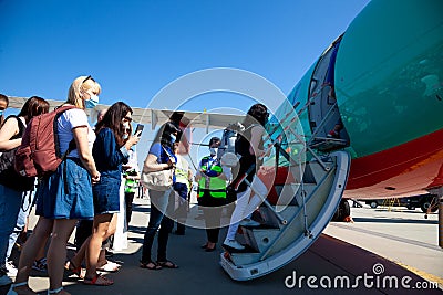 Kyiv, Ukraine - June 27, 2020: Passengers board the plane. Masked people board the flight. Airport Boryspil, Windrose Airlines Editorial Stock Photo
