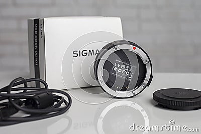 KYIV, UKRAINE - June 15, 2017: Sigma 18-35mm f / 1.8 DC HSM lens for Canon EF. USB-base for alignment Editorial Stock Photo