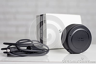 KYIV, UKRAINE - June 15, 2017: Sigma 18-35mm f / 1.8 DC HSM lens for Canon EF. USB-base for alignment Editorial Stock Photo