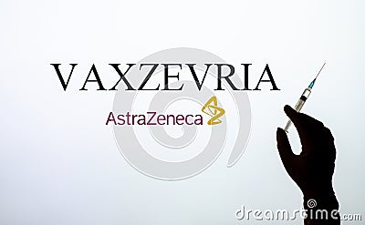 Kyiv, Ukraine - March 30, 2021: Vaxzevria previously COVID-19 Vaccine AstraZeneca concept. Backlit single shot image of hands Editorial Stock Photo