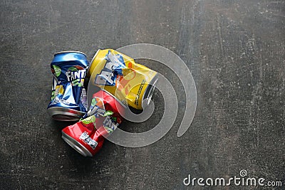 KYIV, UKRAINE - 4 MAY, 2023: Fanta soft drink brand crumpled tin cans with various flavours Editorial Stock Photo