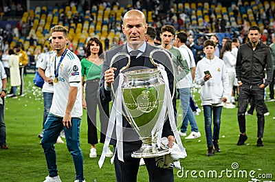 KYIV, UKRAINE - MAY 26, 2018: Zinedine Zidane celebrates and holds the UEFA Champions League trophy during the 2018 UEFA Champion Editorial Stock Photo