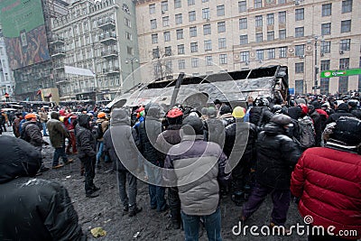 KYIV, UKRAINE: Men crowd turned burned-out bus on Editorial Stock Photo