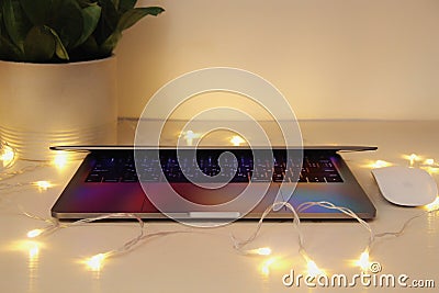 Modern MacBook Laptop computer, Magic Mouse on white in interior Editorial Stock Photo