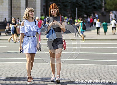 Kyiv, Ukraine - November 14, 2017: Two happy young girls walking Editorial Stock Photo