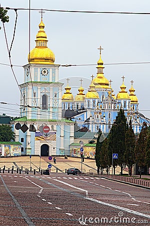 Picturesque cityscape of Kyiv. Wide cobbled road to the Mykhailivska Square with St. Michael`s Golden-Domed Monastery Editorial Stock Photo