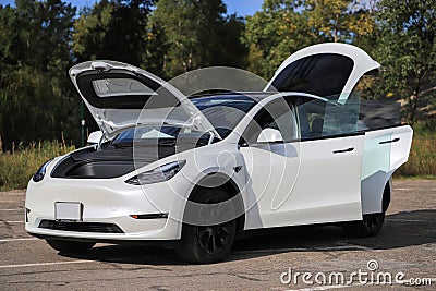 Car Tesla Model Y with open doors Stock Photo
