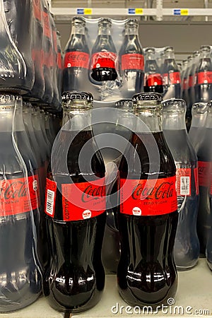 Kyiv, Ukraine, September 24, 2023: - Classic Coca-Cola in stylish glass bottle packaged in row for sale Editorial Stock Photo
