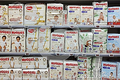 Kyiv, Ukraine - 4 September, 2023: Inside the Auchan supermarket. Showcase with baby diapers Huggies Editorial Stock Photo