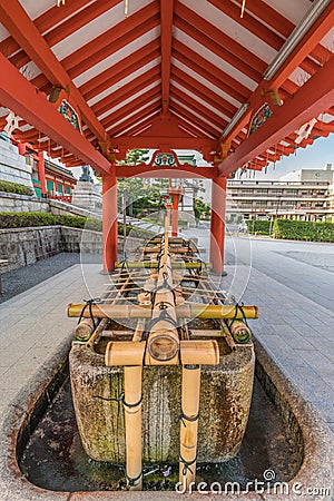 Temizuya or Chozuya (water ablution pavilion) of Fushimi Inari Taisha Shinto Shrine. Early morning view without tourists. Editorial Stock Photo