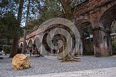 Red brick bridge in Nanzen-ji Temple surrounded by trees and forest Editorial Stock Photo
