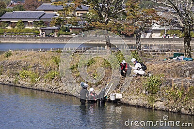 Kyoto, Japan - November 7, 2019: Group of Japanese Professional Male Divers On River for Underwater Construction Works Street of Editorial Stock Photo