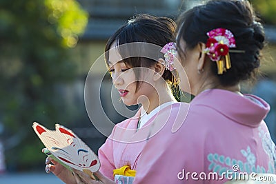 KYOTO, JAPAN - NOVEMBER, 8, 2019: Japanese Ladies Posing in Geisha Kimono At One of the Kyoto Streets, Japan Editorial Stock Photo
