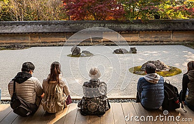 Tourists meditating in the Rock garden Editorial Stock Photo