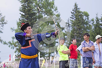 Young man shoots from a sports bow Editorial Stock Photo