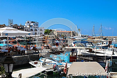 KYRENIA / CYPRUS Yachts, boats and an outdoor restaurant in The Kyrenia Harbor Editorial Stock Photo