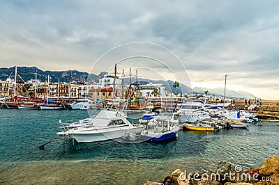 Kyrenia or Girne historical city center, view to marina with many yachts and boats with mountains in the background Editorial Stock Photo