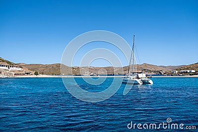 Kythnos Greek island, Kolona sandy beach, yacht background Editorial Stock Photo