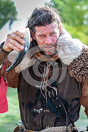 2018-10_06 L`isle Sur La Sorgue , France.Viking saying cheers with horn cup, editorial Editorial Stock Photo