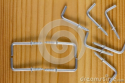 L Shaped Self Tapping Metal Hook on wooden background Stock Photo