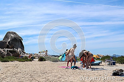 La Maddalena, Sardinia, Italy - Some girls protect their skin with sunscreen Editorial Stock Photo