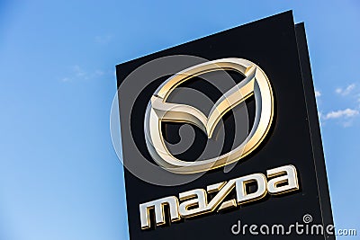 La rochelle, France - August 30, 2016: Official dealership sign of Mazda against the blue sky. Mazda Corporation is a Japanese aut Editorial Stock Photo