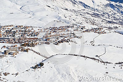 La Toussuire mountain village as seen from high up on the mountain, in Les Sybelles ski domain. Winter view on a sunny day Stock Photo